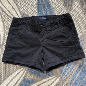 Tan and black pair of American eagle shorts